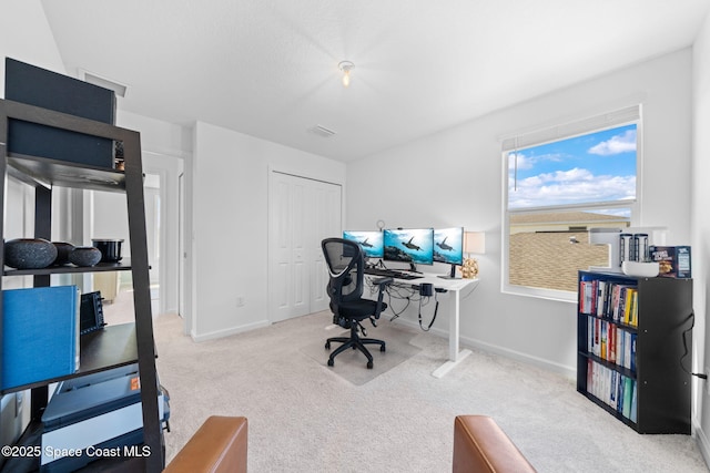 carpeted home office featuring visible vents and baseboards