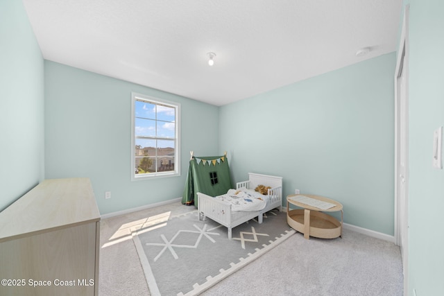 carpeted bedroom featuring baseboards