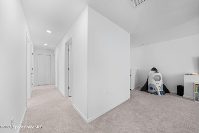 corridor featuring recessed lighting, light carpet, visible vents, and baseboards