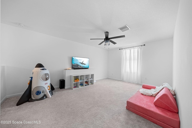 recreation room featuring carpet floors, baseboards, visible vents, and a ceiling fan