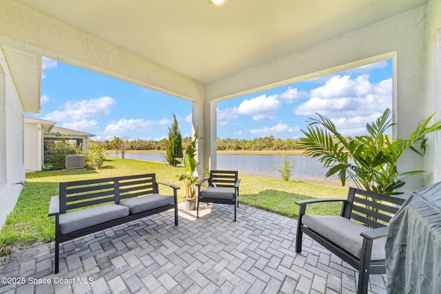 view of patio with a water view and central AC