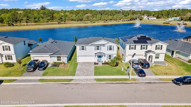 drone / aerial view featuring a residential view and a water view