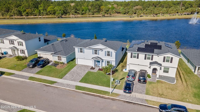 drone / aerial view featuring a residential view and a water view