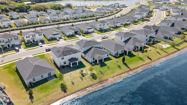 birds eye view of property with a water view and a residential view