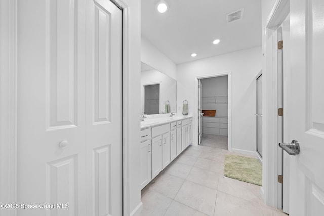 full bath featuring visible vents, tile patterned flooring, a walk in closet, vanity, and recessed lighting