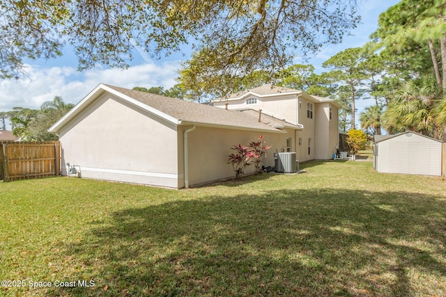 view of property exterior featuring central AC, a lawn, fence, and stucco siding