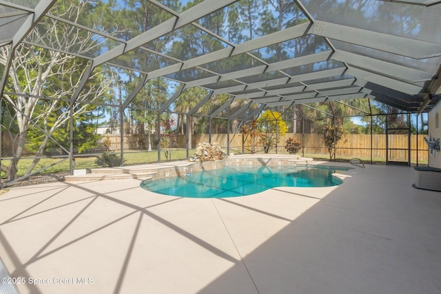 view of swimming pool featuring glass enclosure, a patio area, a fenced backyard, and a fenced in pool