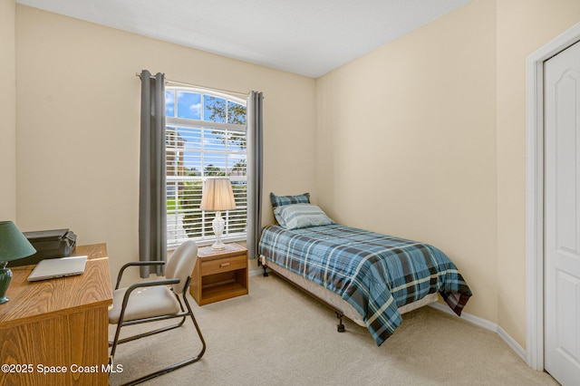 bedroom featuring carpet floors and baseboards