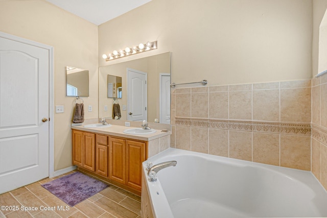 full bathroom with wood tiled floor, a garden tub, a sink, and double vanity