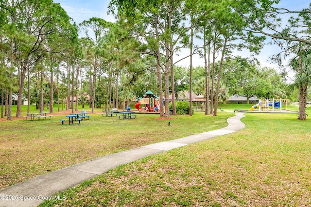 view of community with playground community and a yard