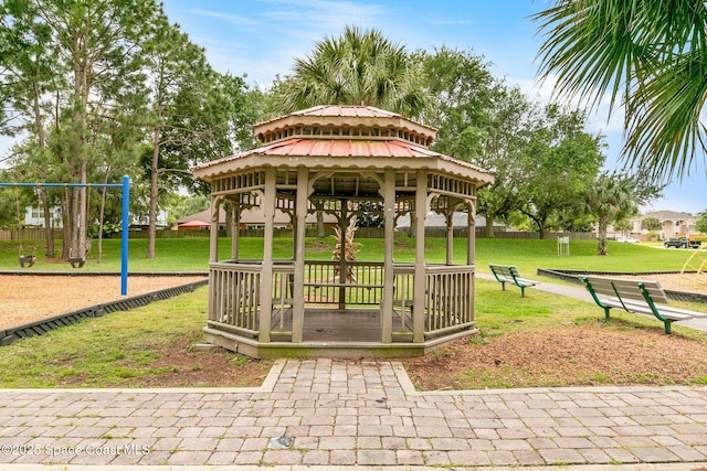 surrounding community featuring playground community, a lawn, and a gazebo