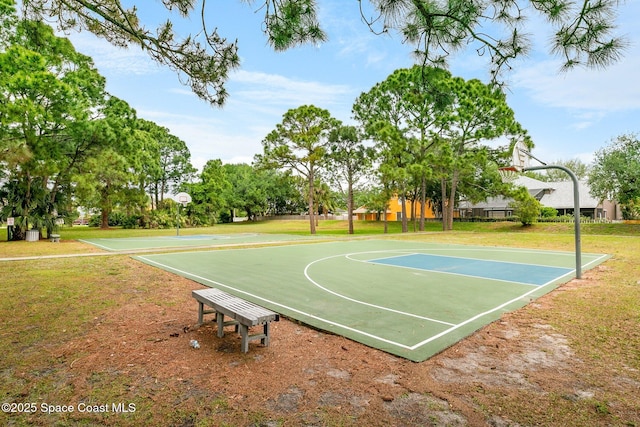 view of basketball court with a yard and community basketball court