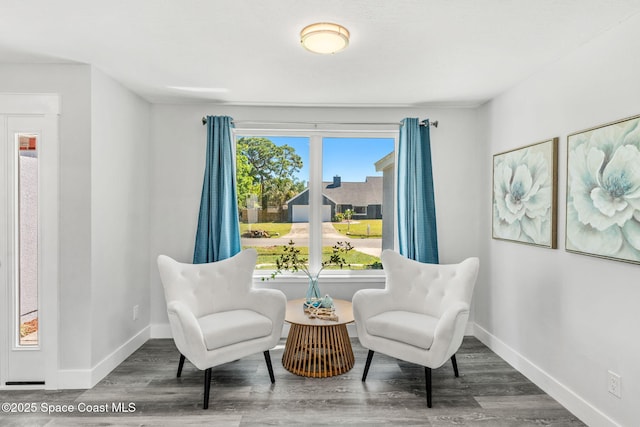 sitting room featuring baseboards and wood finished floors