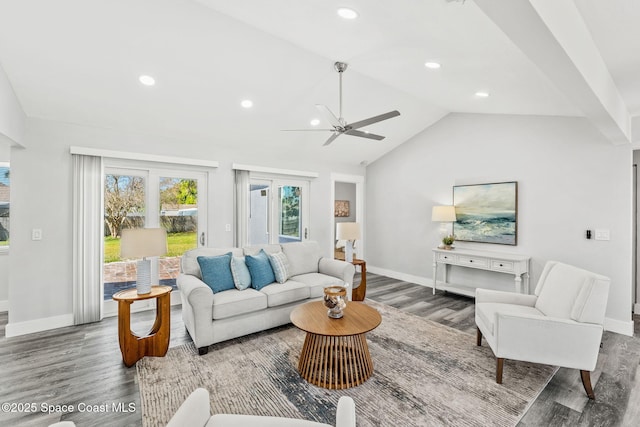 living room featuring lofted ceiling, baseboards, wood finished floors, and recessed lighting