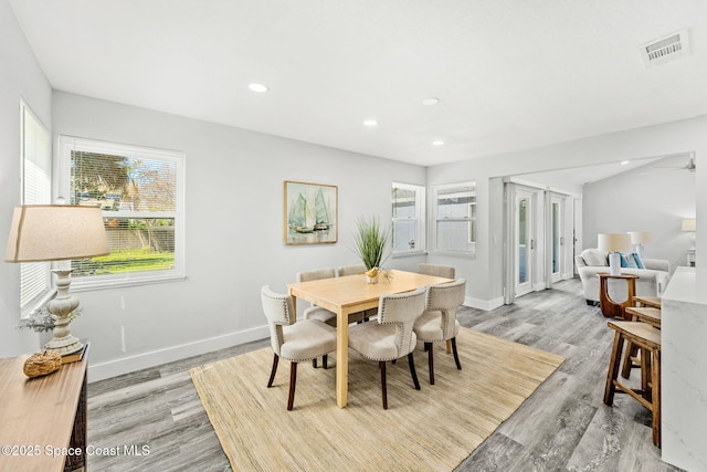 dining area with light wood-style floors, baseboards, visible vents, and recessed lighting