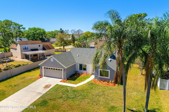 view of front of home featuring a garage, fence, driveway, stucco siding, and a front lawn