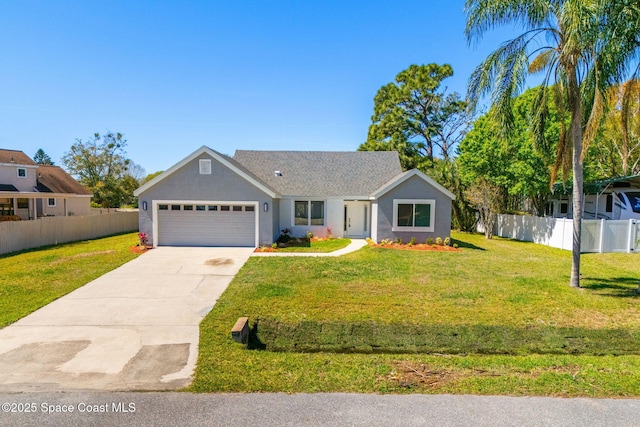 view of front of home with stucco siding, concrete driveway, a front yard, fence, and a garage