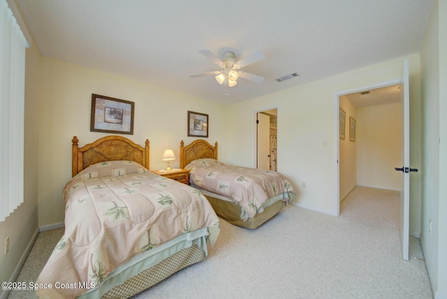 carpeted bedroom with ceiling fan, visible vents, and baseboards