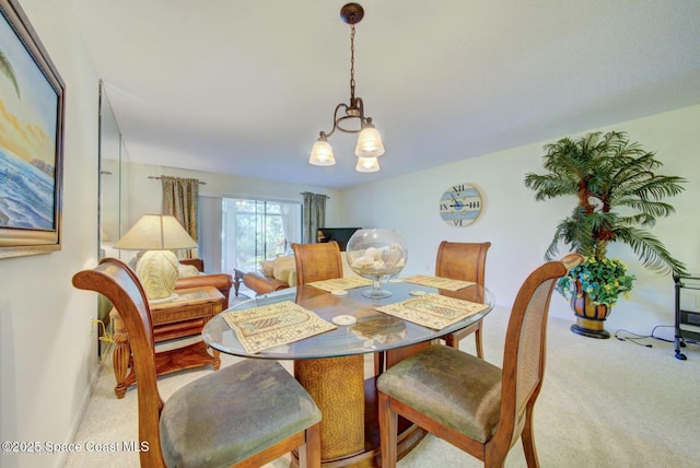 dining space with light carpet and an inviting chandelier