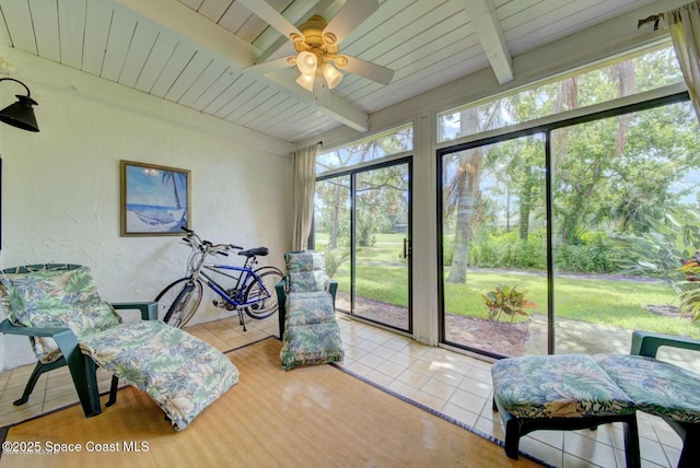 sunroom featuring wood ceiling, ceiling fan, and beamed ceiling