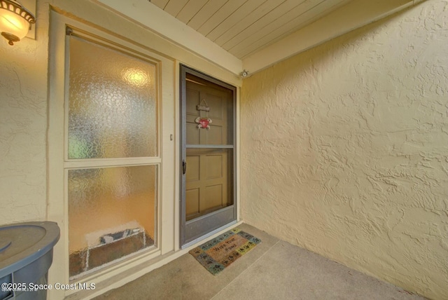 property entrance with stucco siding