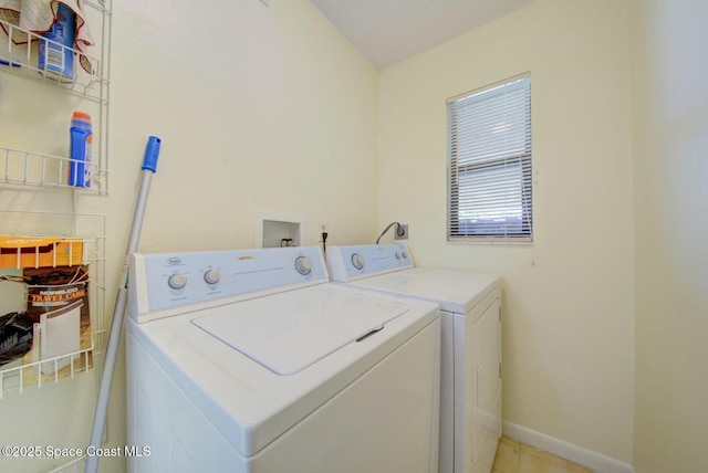 laundry room with laundry area, baseboards, and washing machine and clothes dryer