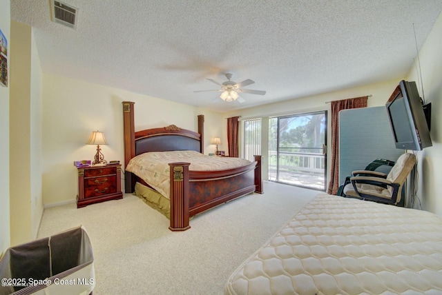 carpeted bedroom featuring access to exterior, visible vents, ceiling fan, and a textured ceiling