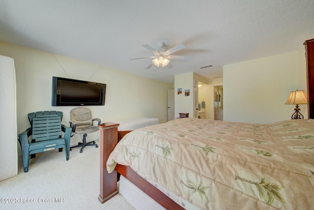 carpeted bedroom featuring ceiling fan and a textured ceiling