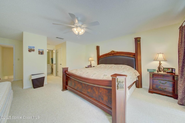 carpeted bedroom featuring ceiling fan, visible vents, and baseboards