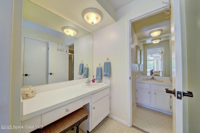 full bathroom featuring tile patterned floors, baseboards, and vanity