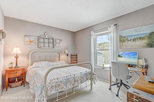 bedroom featuring carpet flooring, a textured ceiling, and baseboards