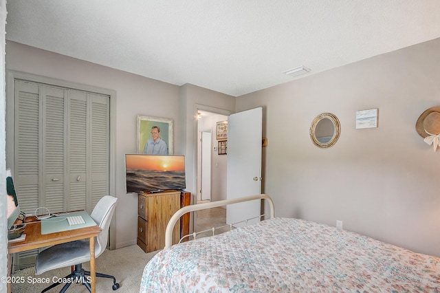 bedroom featuring a closet, visible vents, and light colored carpet