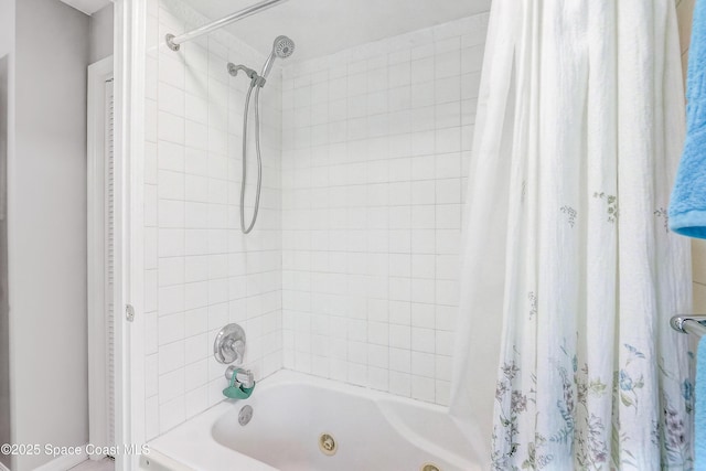 bathroom with a combined bath / shower with jetted tub