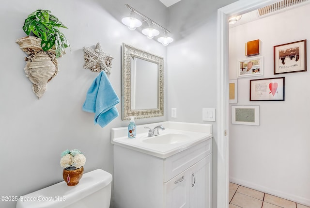 bathroom featuring toilet, tile patterned flooring, vanity, and visible vents