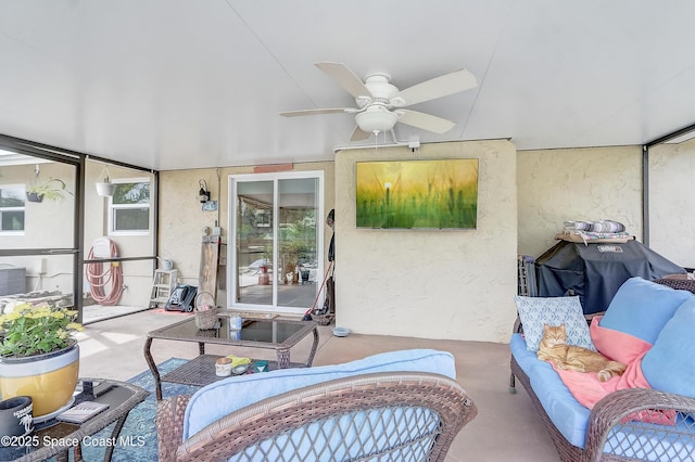 sunroom / solarium featuring ceiling fan