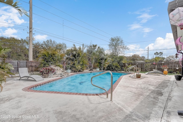 view of swimming pool with a fenced in pool, a fenced backyard, and a patio