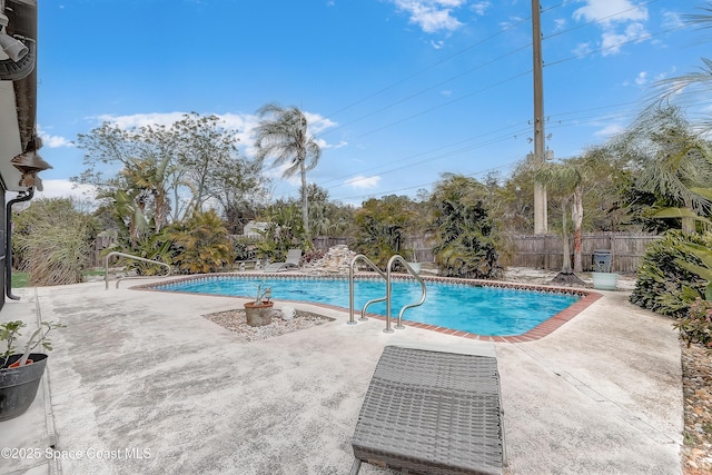 view of swimming pool featuring a patio, a fenced backyard, and a fenced in pool