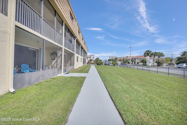 surrounding community featuring a lawn and fence