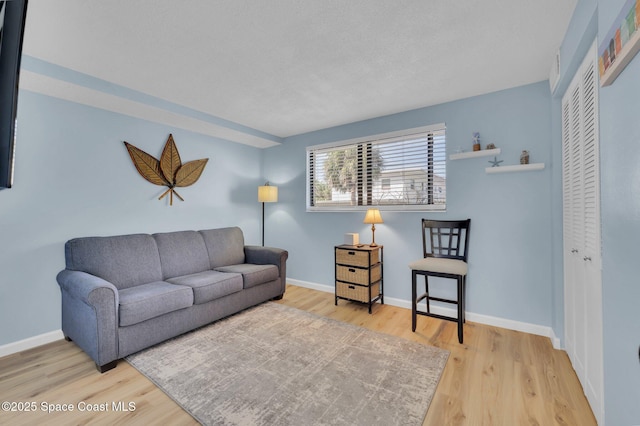 living room with wood finished floors and baseboards