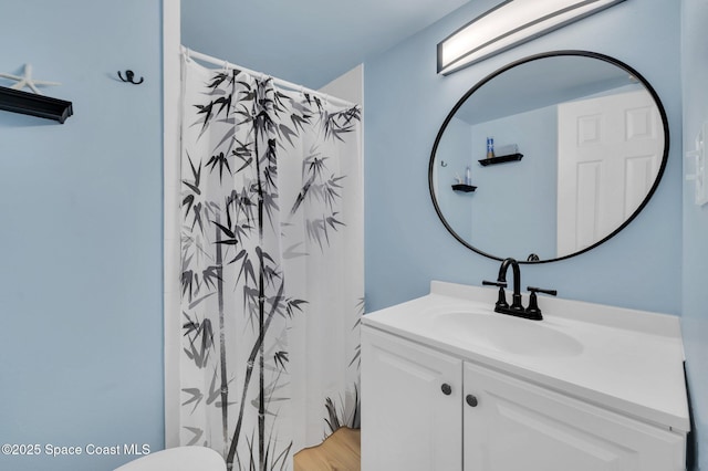 bathroom with curtained shower and vanity