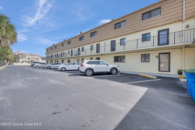 uncovered parking lot with a residential view