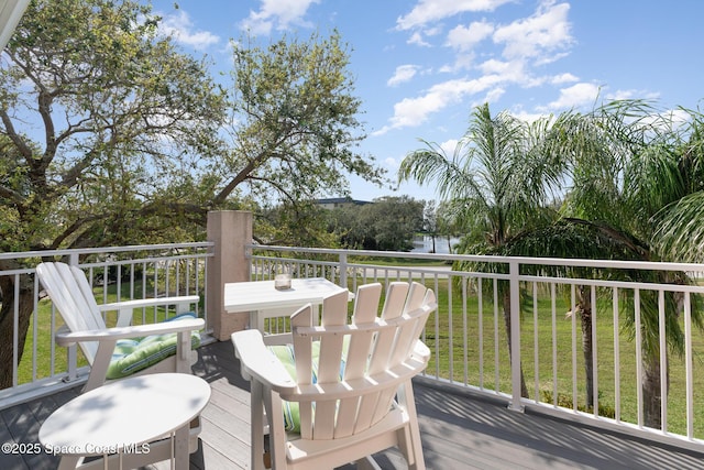 wooden deck featuring a yard