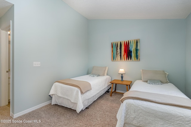 carpeted bedroom featuring baseboards