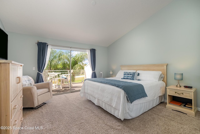 bedroom featuring access to exterior, vaulted ceiling, and carpet floors