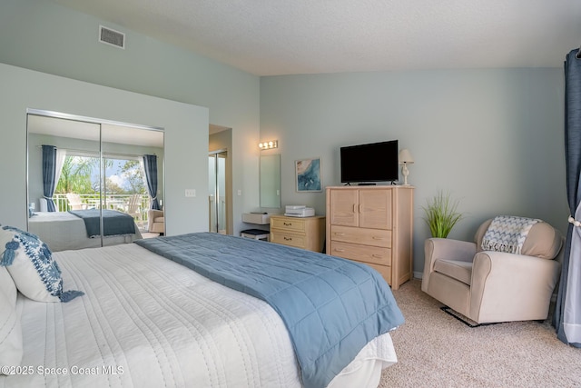 bedroom featuring light carpet, lofted ceiling, and visible vents