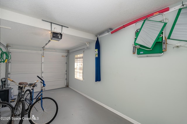 garage with a garage door opener and baseboards