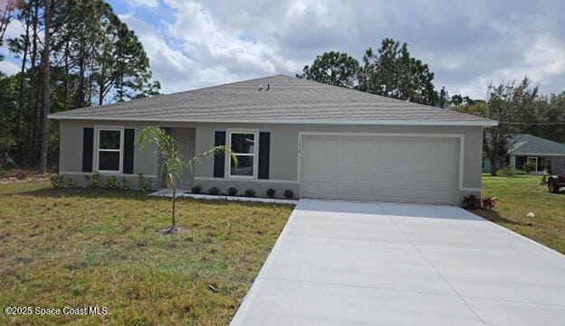 single story home featuring stucco siding, driveway, an attached garage, and a front lawn