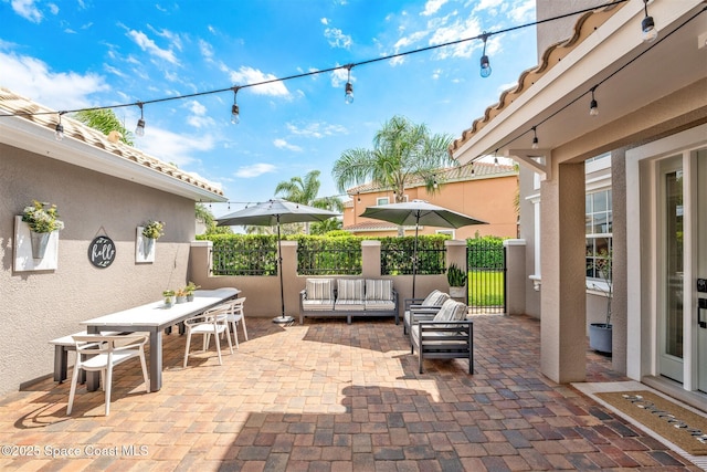 view of patio / terrace featuring outdoor dining space, fence, and an outdoor living space