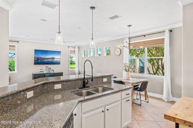 kitchen with crown molding, a sink, and visible vents