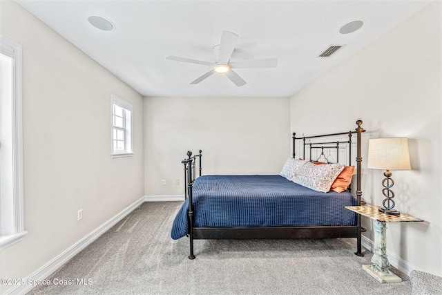 carpeted bedroom featuring visible vents, baseboards, and ceiling fan